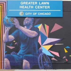 A finished look at the mural of a man in a wheelchair shooting a globe like a basketball. Artist Terence Byas said the image represents “the human spirit triumphing.”