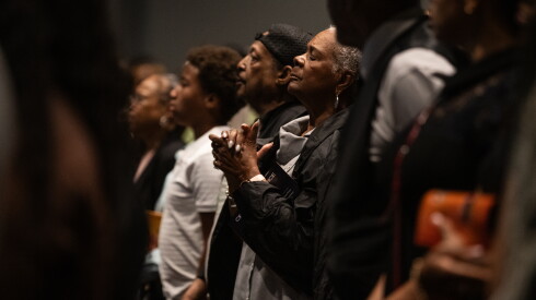 Mourners pray during Tim Bankston's memorial service.