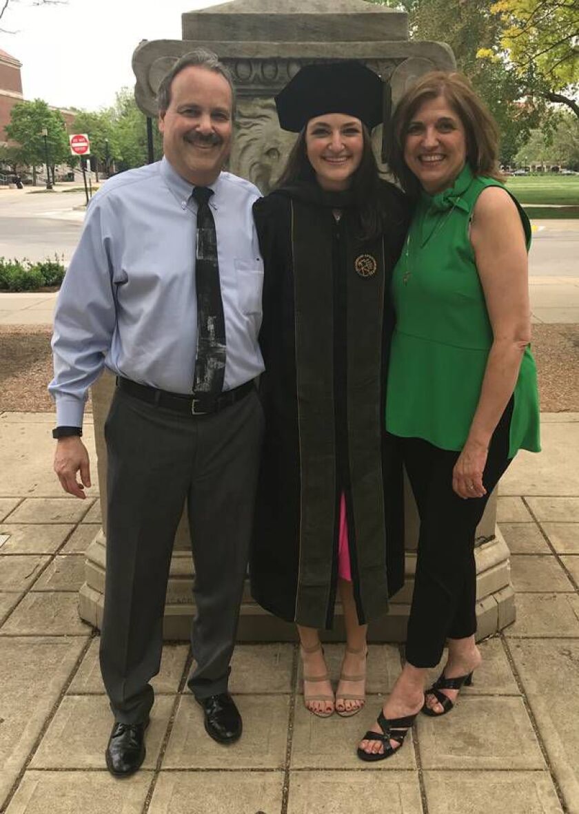 Dayna Less with her parents.