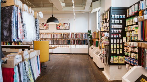 Inside the Atlanta showroom of Mood Fabrics, with fabric samples hanging along the walls.