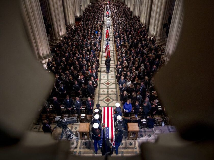 The flag-draped casket of former President George H.W. Bush is carried by a military honor guard during a State Funeral at the National Cathedral in Washington D.C. | AP photo