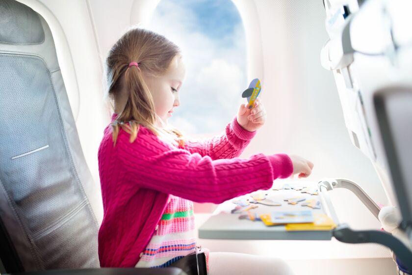 To help keep kids entertained during a plane ride or long car ride, consider bringing along some portable, age-appropriate distractions like puzzles.