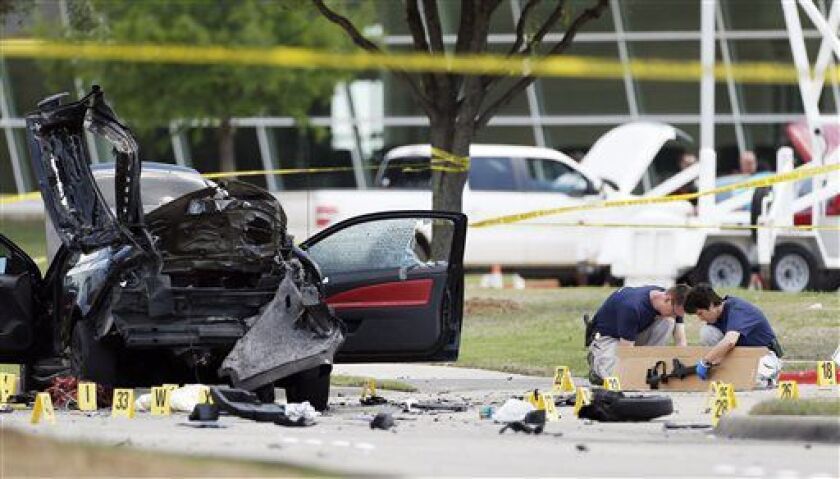 <small><strong>Investigators box up an assault weapon on Monday outside the Curtis Culwell Center in Garland, Texas. | Brandon Wade/AP</strong></small>