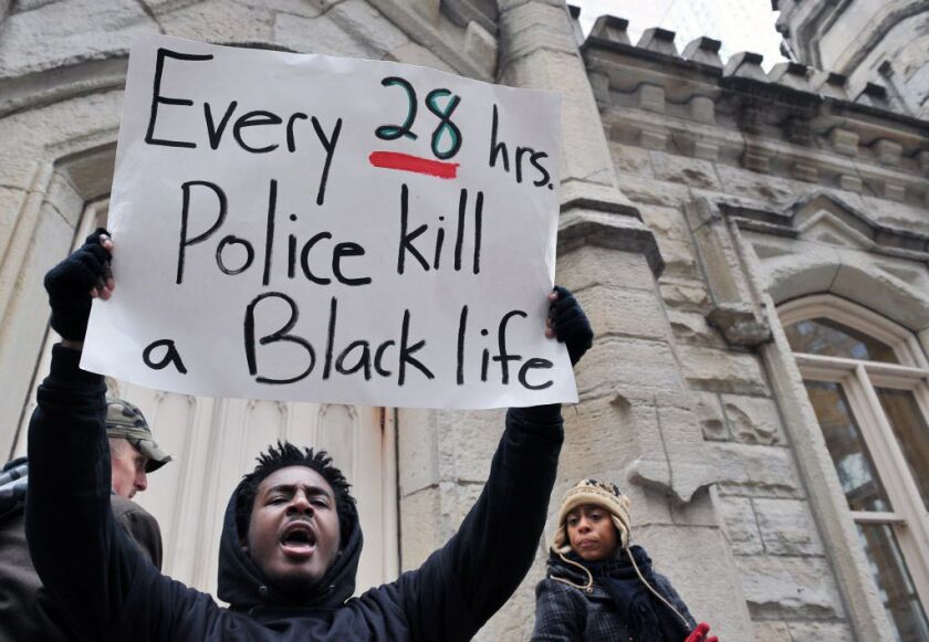 <small><strong>Malcolm London of Chicago who is with Black Youth Project carried a sign saying that every 28 hours police kill a black life. Protestors came to the Water Tower on Michigan Avenue in Chicago to protest police action in Ferguson, Missouri