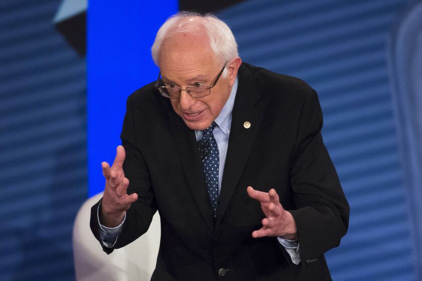 Democratic presidential candidate Sen. Bernie Sanders, I-Vt., answers a question from the audience during a democratic primary town hall sponsored by CNN. | John Minchillo/AP