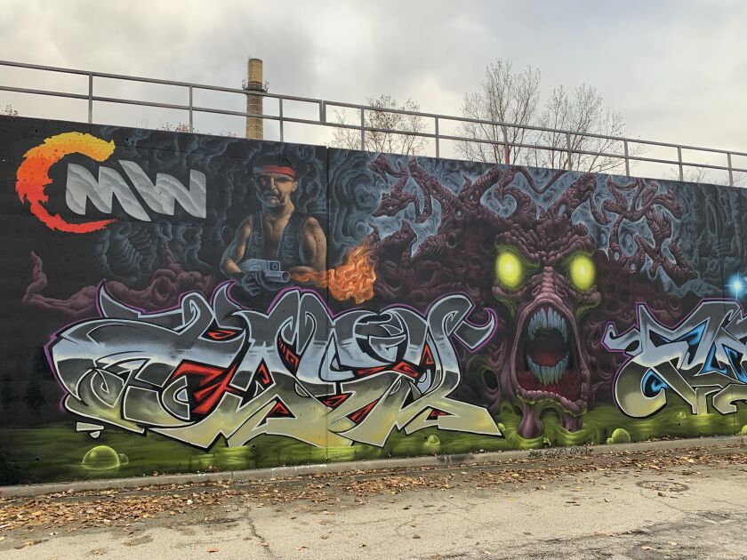 Images of the CMW graffiti team, inspired by the video game Contra. The artist who goes by Yoki made the character and the Rambo-like creature to his right.