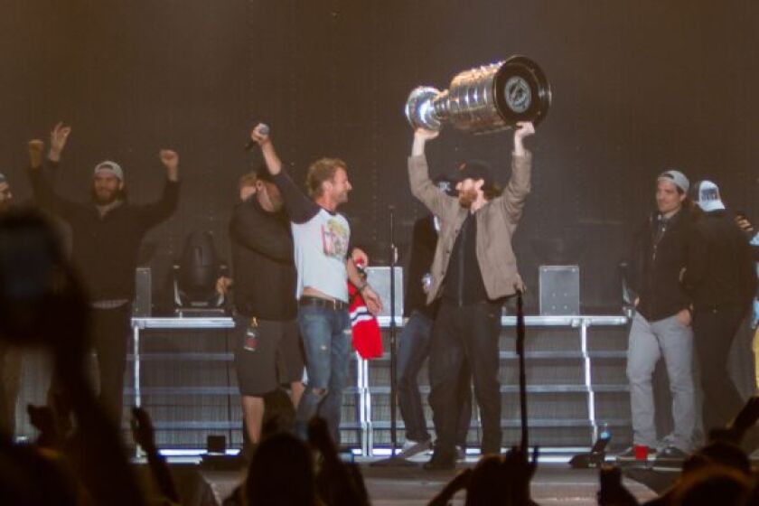 The Blackhawks’ Duncan Keith prepares to hand the cup to country music star Dierks Bentley at Windy City LakeShake Friday night. | PHOTO COURTESY KENNY WILLIAMSON