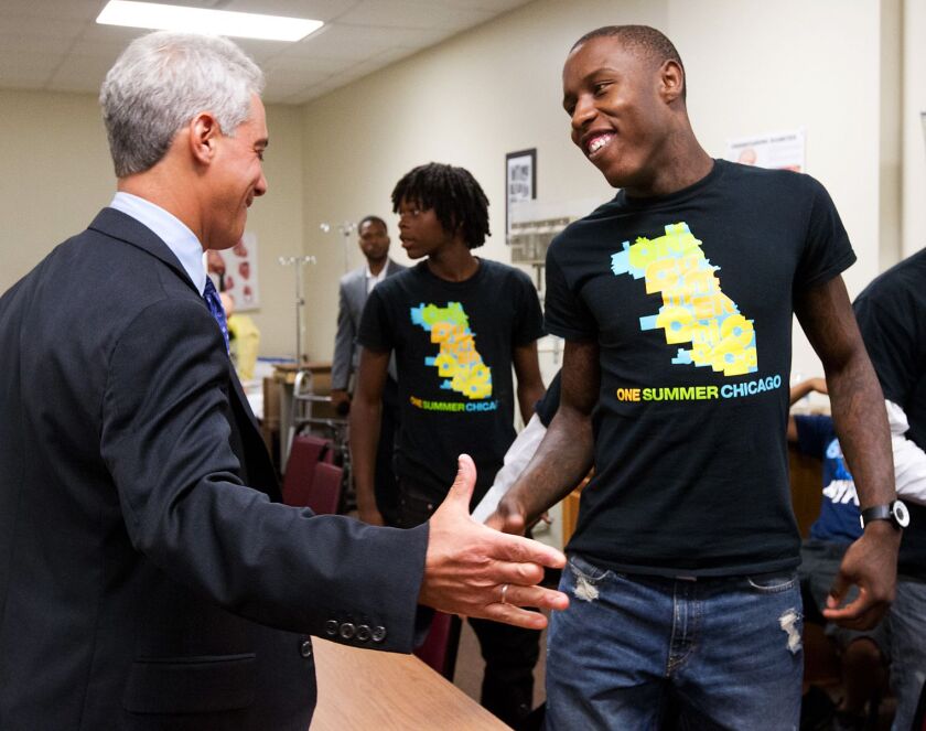 Mayor Rahm Emanuel shakes hands with Phillip Lee, one of the youths hired through the One Summer Plus program, in 2013.
