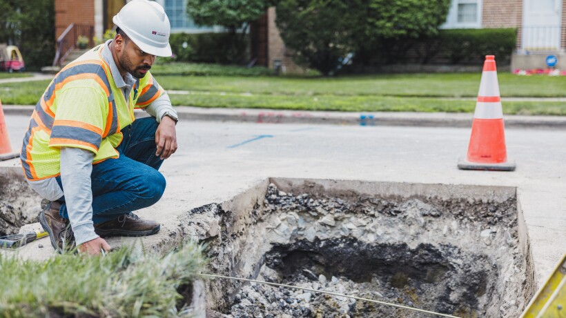 A worker replaces a lead pipe.