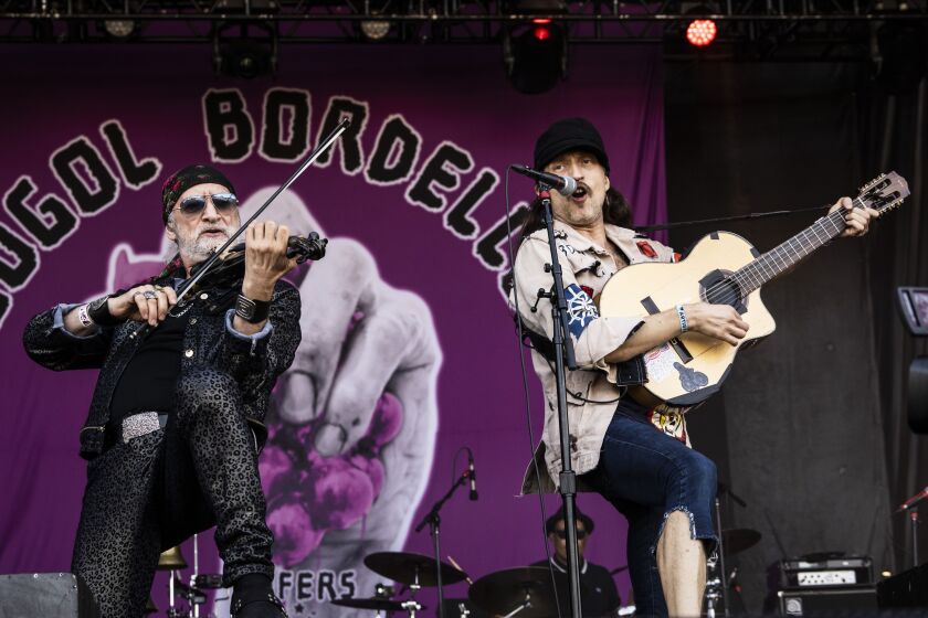 Sergey Ryabtsev and Eugene HŸtz, of Gogol Bordello, performs on Day 3 of Riot Fest.