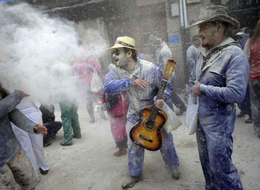A man throws flour to another during the “Domingo Fareleiro” (floury Sunday in Galician language) carnival festival in the village of Xinzo de Limia, northwestern Spain, on January 25, 2015. MIGUEL RIOPA/AFP/Getty Images