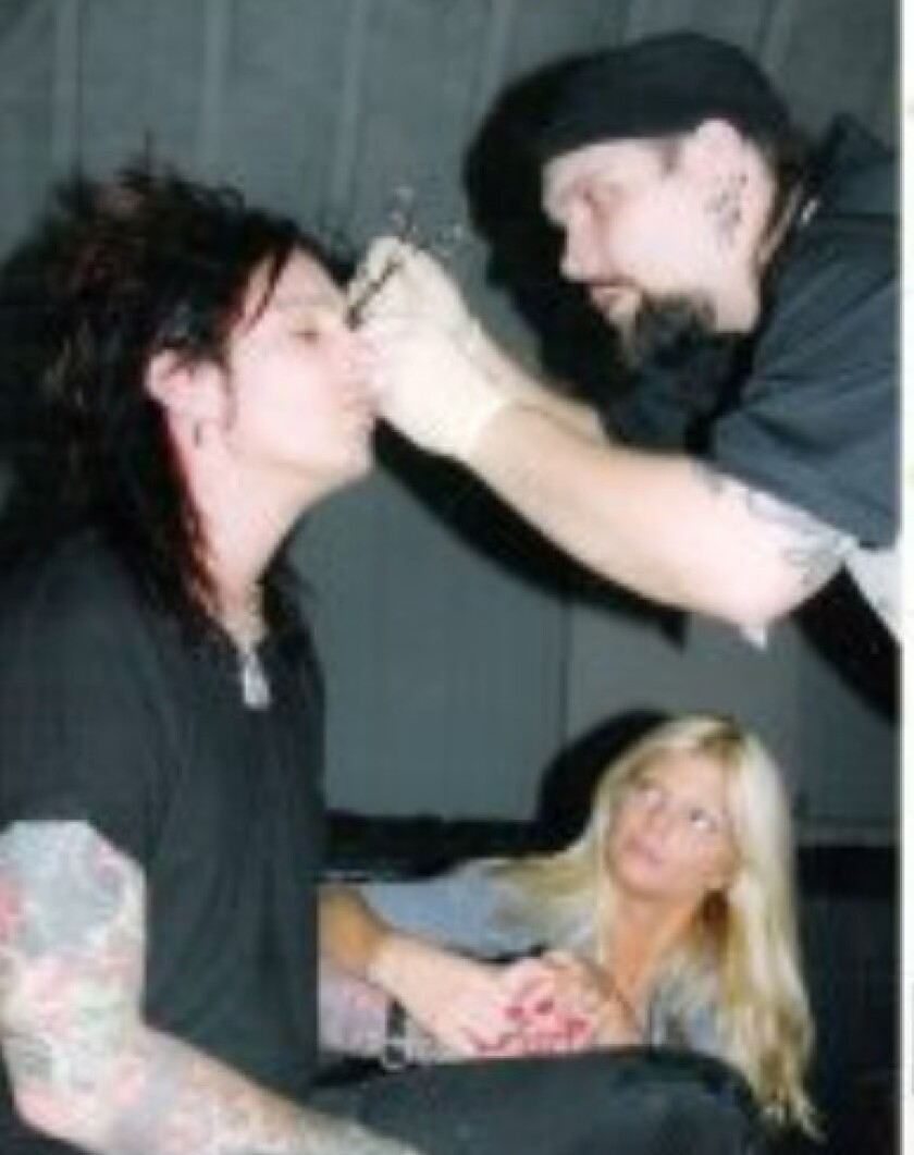 A young Henry Anderson piercing Nikki Sixx of Motley Crue. | Facebook photo