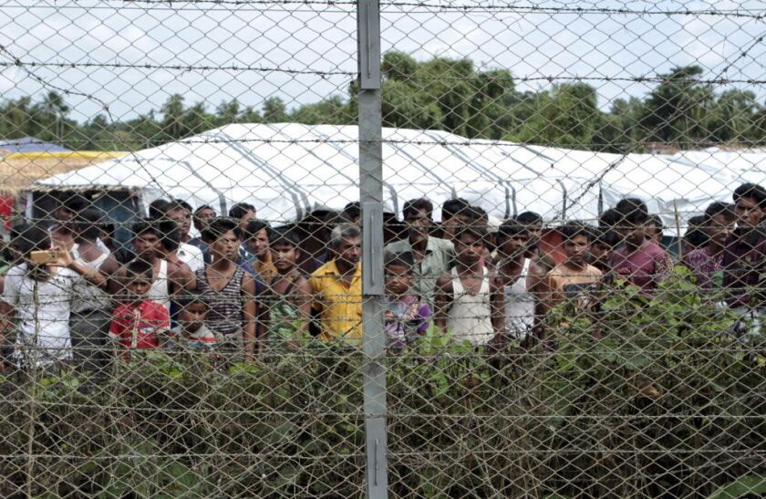 Rohingya refugees gather during a government-organized media tour in late June of a no-man’s land between Myanmar and Bangladesh in northern Rakhine State where thousands of Rohingya Muslims are still living. | AP