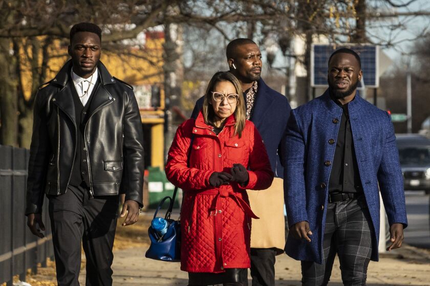 (From left) Abimbola Osundairo, attorney Gloria Schmidt Rodriguez, a man who identified himself as a bodyguard and Olabinjo Osundairo walk into the Leighton Criminal Courthouse for the Jussie Smollett trial Thursday morning.