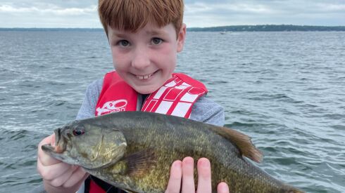 Lucas Peterson of St. Charles holds a smallmouth bass caught on an guide trip with Mike Norris on Big Green Lake.