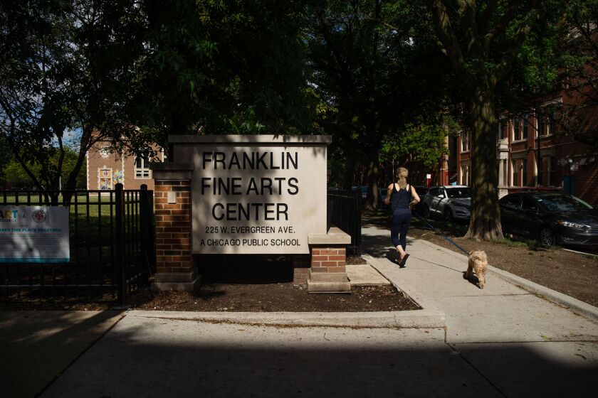 A person jogs past the Franklin Fine Arts Center in the Near North Side on June 23, 2020.