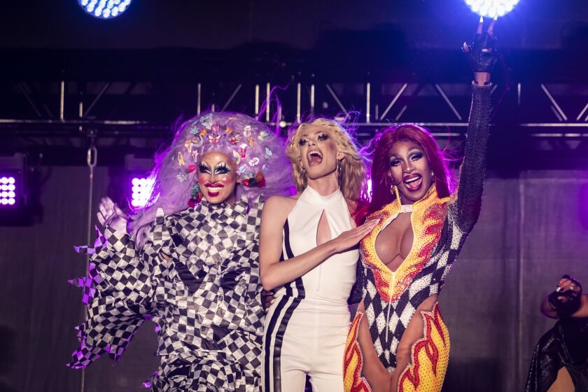 Crystal Methyd (from left), Gigi Goode and Jaida Essence Hall wave to the crowd during Drive ‘N Drag at Soldier Field. Hall won the 12th season of “RuPaul’s Drag Race”; Methyd and Goode were runners-up.