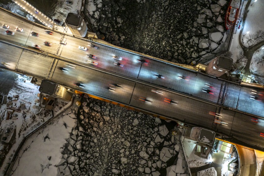 Vehicles travel north and southbound across the Outer Drive Bridge that spans across the Chicago River, Tuesday, Feb. 3, 2026.