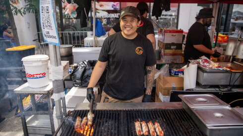 Lee Concessions manager Austin Ly flips hot dogs at the Windy City Hot Dog Fest.