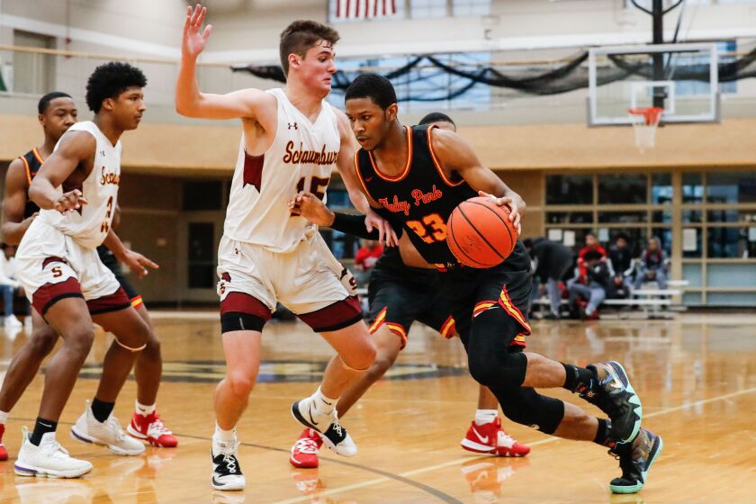Tinley Park’s AJ Casey drives the ball past Schaumburg’s Jared Schoo (15).
