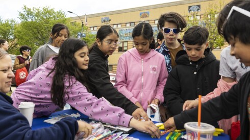 Community organizations and businesses set up tables outside Orozco Academy.