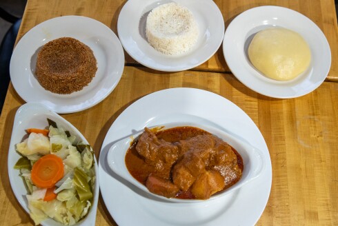 Maffe, a Senegalese peanut stew, served with (clockwise from left) cooked vegetables, jollof rice, white rice, and fufu, at Yassa African Restaurant at 3511 S. King Drive on Wednesday, Nov. 13, 2024. | Zubaer Khan/Sun-Times