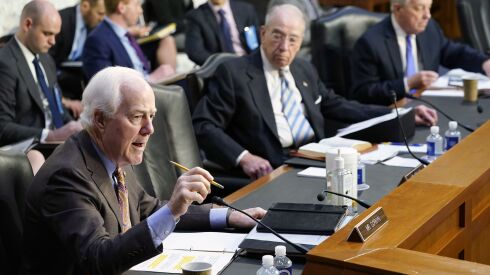 Cornyn, R-Texas, (left) speaks during the Senate Judiciary Committee confirmation hearing for Supreme Court nominee Judge Ketanji Brown Jackson on Wednesday, March 23, 2022. Senate Judiciary Committee Chairman Sen. Dick Durbin, D-Ill. (right) and ranking member Sen. Chuck Grassley, R-Iowa, (center) listen.