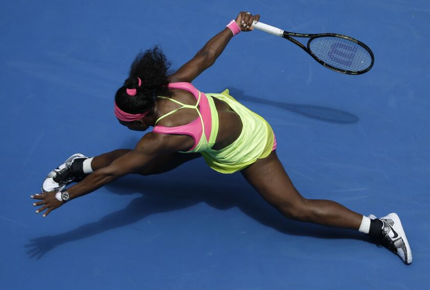 Serena Williams of the U.S. stretches out for a shot to Garbine Muguruza of Spain during their fourth round match at the Australian Open tennis championship in Melbourne, Australia, Monday, Jan. 26, 2015. (AP Photo/Bernat Armangue)