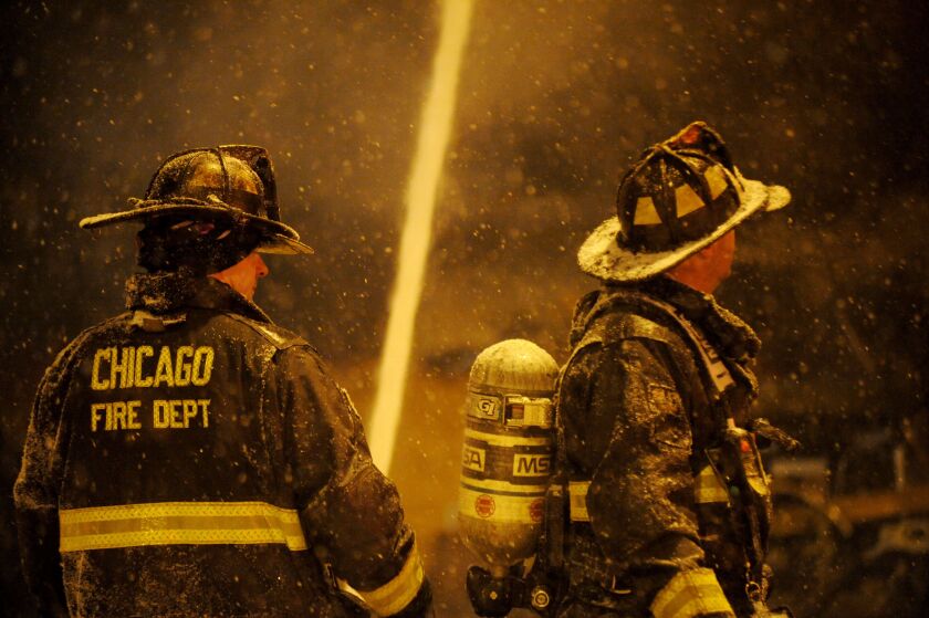 Firefighters battling an extra-alarm fire early Friday in the 2900 block of West 63rd Street as a winter storm moves through the area. | Justin Jackson/Sun-Times