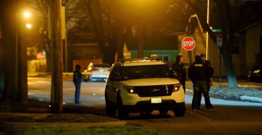 Police investigate the scene of a shooting in Gresham on March 28. | Justin Jackson/ Sun-Times