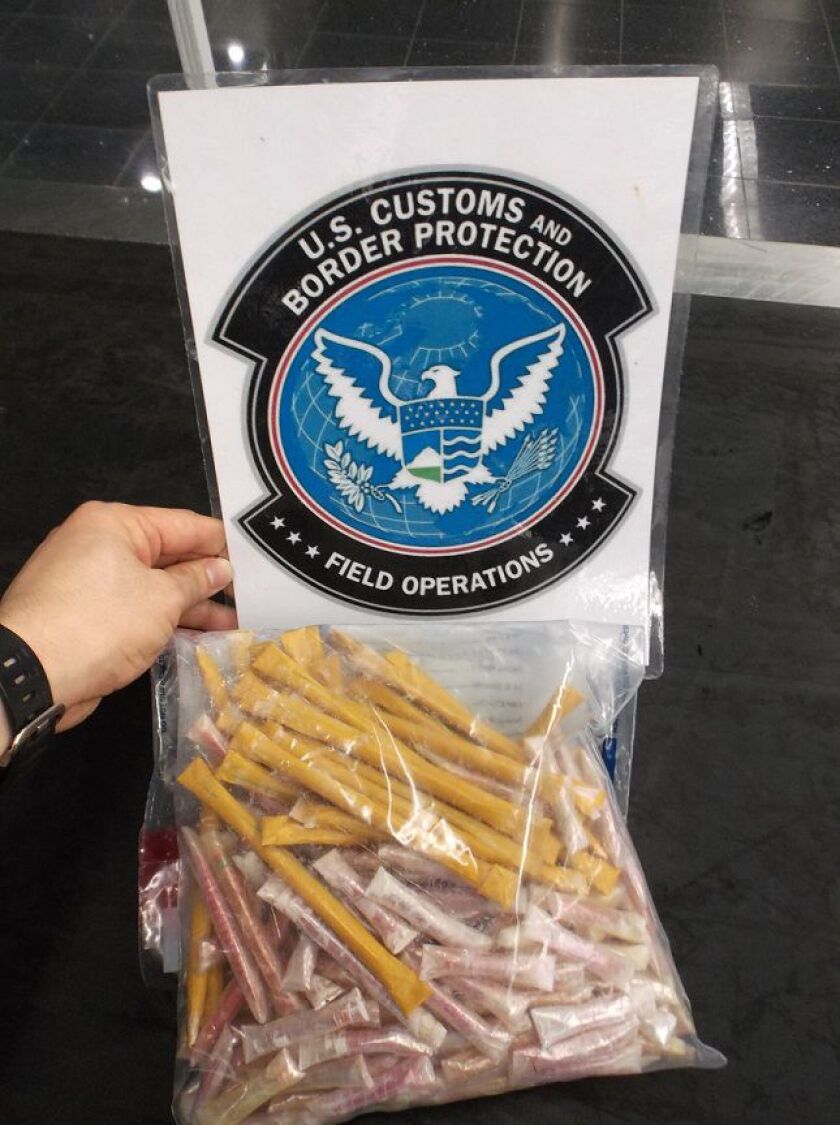A 49-year-old Minnnesota woman was arrested with opium and methamphetamine pills in her luggage at O’Hare. | Cook County sheriff’s office