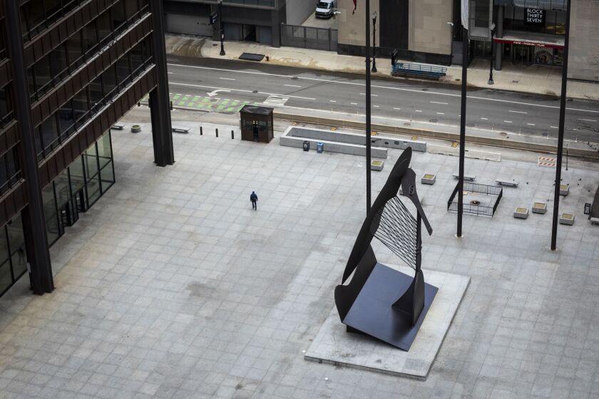 Amid fears of the coronavirus pandemic and a stay-at-home order from Gov. J.B. Pritzker, a man has Daley Plaza to himself as he walks through the Loop, as seen from the roof of City Hall during the Wednesday morning commute, April 1, 2020.