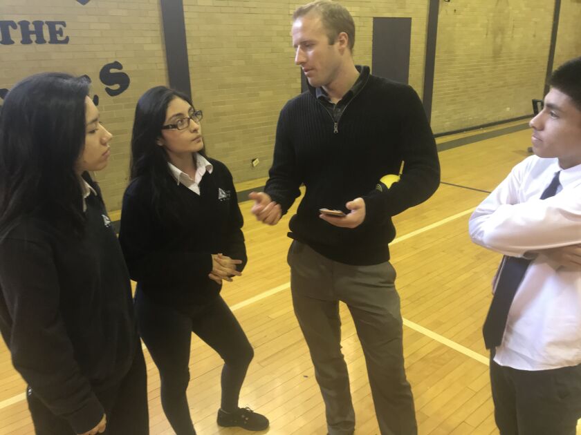 Jamie Pena, (from left) Samantha Armira, CEO facilitator Ike Muzikowski and Giovany Armira work on a marketing video for the program’s spikeball tournament. | Shia Kapos/For the Sun-Times