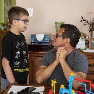 Oliwier “Oli” Kluzik, 12, chats with his uncle Marek Kalinowski at the Northwest Side home Kluzik shares with his grandmother.