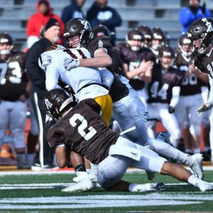 Joliet Catholic’s Scott Fosen (99) and Fernando Chavez (2) sacks Montini’s quarterback Deontay Bell. Worsom Robinson/For the Sun-Times.