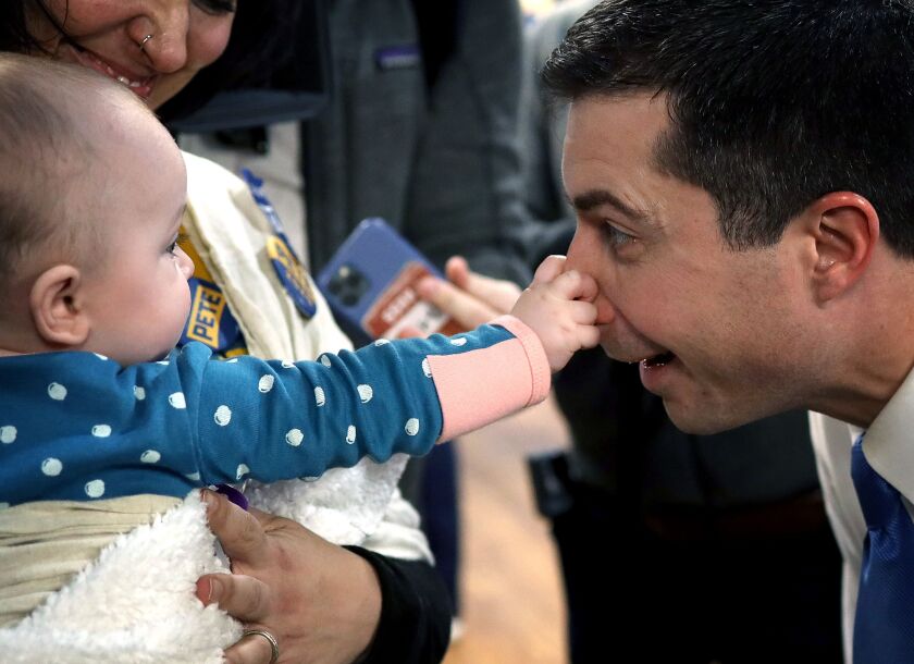 Seven month old Emerson Buckman grabs the nose of Democratic presidential candidate former South Bend, Indiana Mayor Pete Buttigieg in West Des Moines, Iowa.