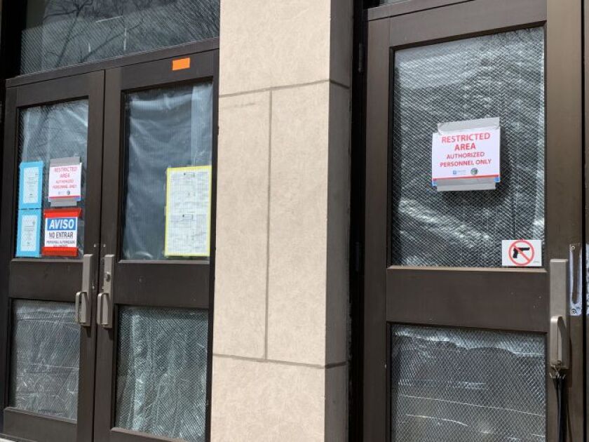 Warning signs are taped to an entrance at Camras Elementary on Wednesday afternoon. | Mitchell Armentrout/Sun-Times