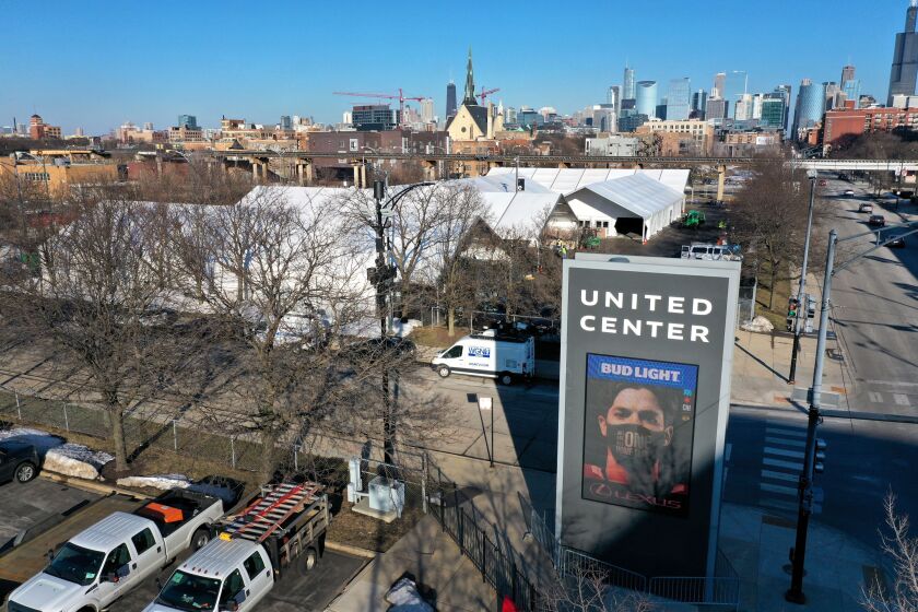 An aerial photo shot with a drone shows a COVID-19 vaccination center being constructed in a parking lot at the United Center. Appointments were still available for seniors Saturday.
