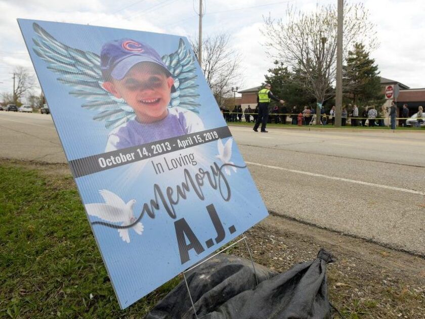 Signs and ribbons line the street in front of the Davenport Family Funeral Home, where the visitation of 5-year-old AJ Freund of Crystal Lake was held last week in Crystal Lake. | Mark Black/For the Sun-Times