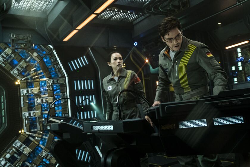 Ziyi Zhang (left) and Daniel Bruhl in “The Cloverfield Paradox.” | NETFLIX