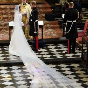 Prince Harry and Meghan Markle stand at the altar together before the Archbishop of Canterbury Justin Welby. | OWEN HUMPHREYS/AFP/Getty Images