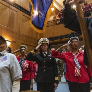 Women veterans of every branch of the U.S. military, salute as the honor guard file into an auditorium at the Pritzker Military Museum and Library for the announcement of the first all women honor flight to Washington D.C. later this year, Tuesday, Feb. 25, 2020.
