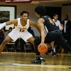 Lindblom’s Myles Twyman (12) defends against Solorio’s Donovan Jones (4).