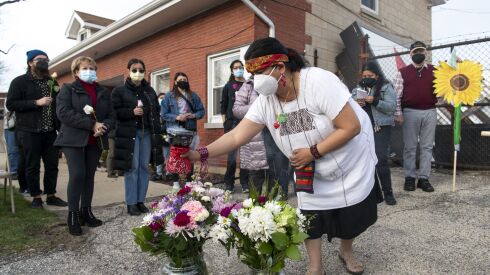 Alicia Saucedo of Little Village blesses flowers in April to mark the second anniversary of the Crawford plant implosion that spewed a massive dust cloud over the neighborhood.