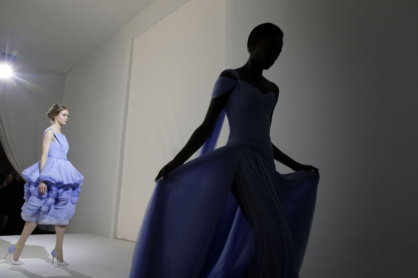 Models walk back to the backstage during the Ralph & Russo’s Spring-Summer 2015 Haute Couture fashion collection presented in Paris, France, Thursday, Jan. 29, 2015. (AP Photo/Christophe Ena)