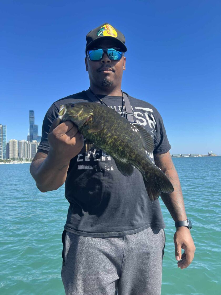 Big T with a smallmouth bass from Lake Michigan. Provided by Jeffrey Williams