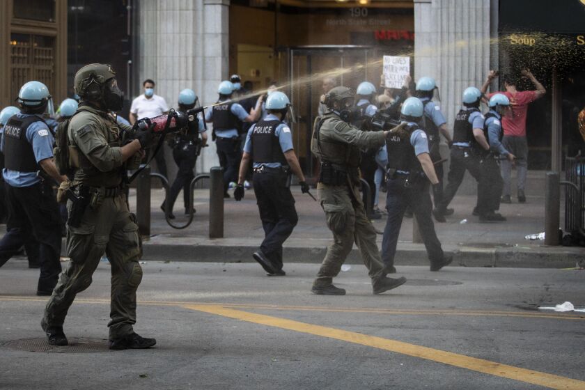 Law enforcement unleashes a stream of pepper spray at protesters on State near Lake in the Loop as thousands in Chicago joined national outrage over the killing of George Floyd in Minneapolis police custody, Saturday afternoon, May 30, 2020. 