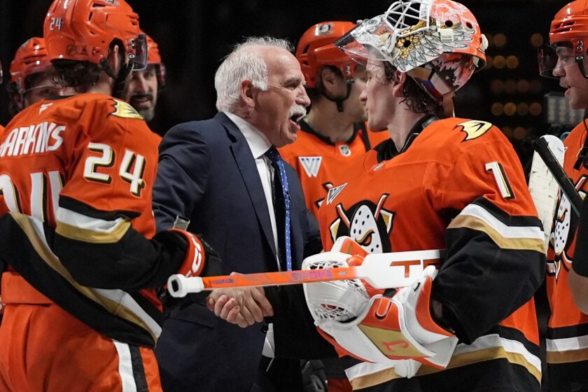 Anaheim Ducks head coach Joel Quenneville, center, celebrates with his players after winning his 1,000th game as a head coach with a 6-4 win over the Edmonton Oilers on Wednesday, Feb. 25, 2026, in Anaheim, California.