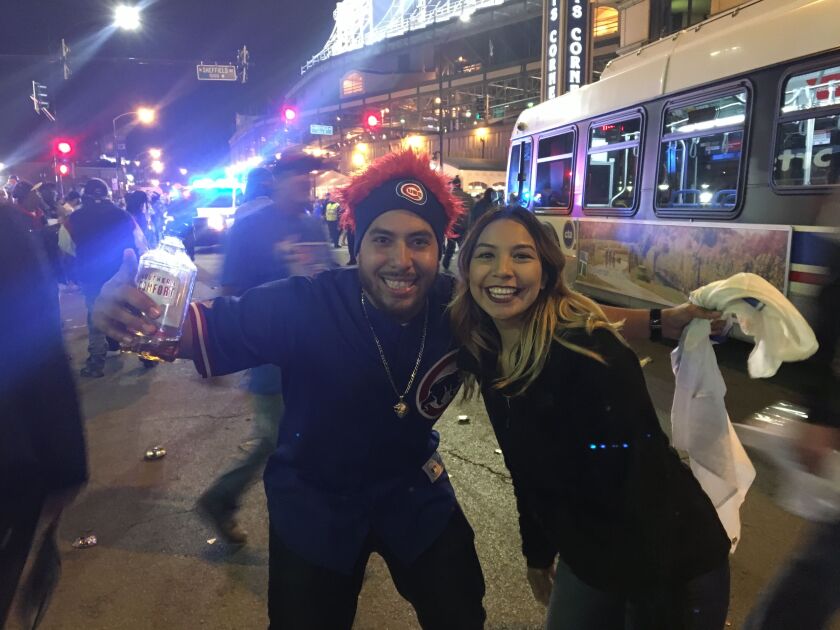 From left, Sarah Guillermo and Oscar Leon celebrate. “This only happens every 71 years, so to be here right now is everything,” Oscar Leon said. “ | Jacob Wittich / Sun-Times