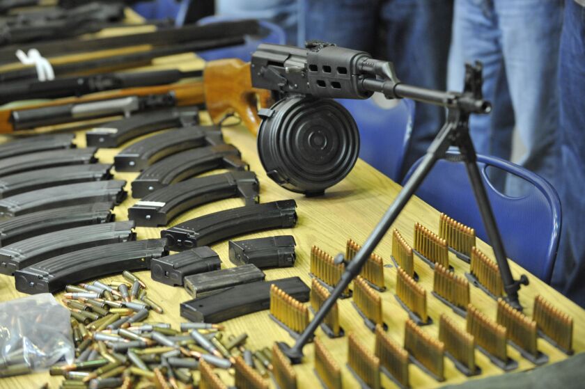 Chicago police have dealt with the proliferation of guns for years. These weapons, drugs and cash were seized in 2010. The firearm in the foreground is an AK-47 with a 75-round magazine. | Sun-Times file photo